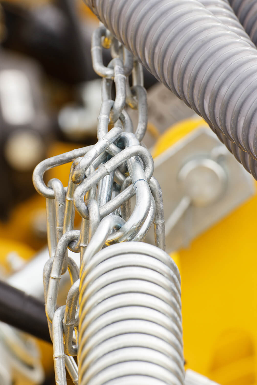 Torsion spring holding chains for manufacturing equipment.